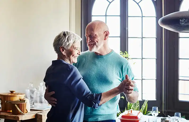 elderly couple dancing together