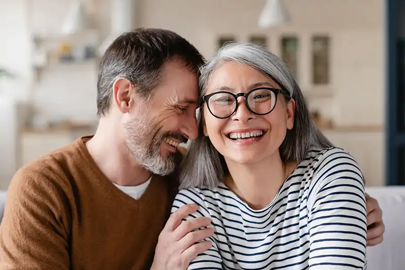 older couple holding each other and smiling